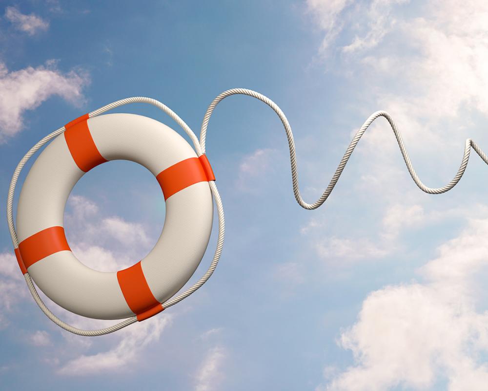 image of life preserver being thrown across a bright sky with a few white clouds