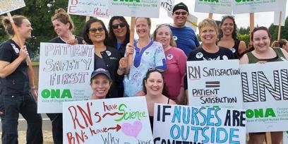 nurses stand with signs