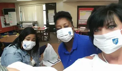 Jefferson County AFT members wearing mold masks