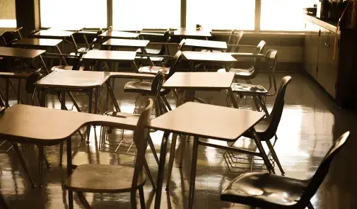 empty classroom shows empty desks all facing the left