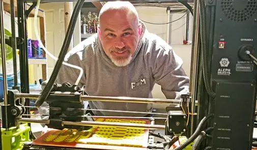 Michael Shunney pictured with 3D printer