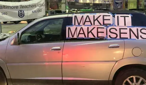 car that says make it make sense on the window