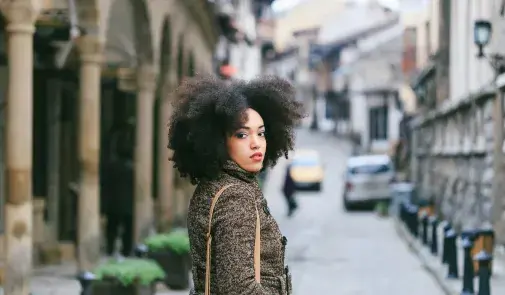 black woman looks back at camera