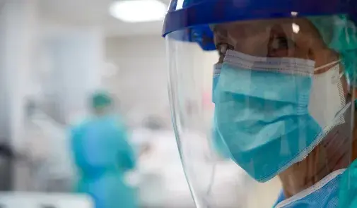 healthcare worker with mask and face shield