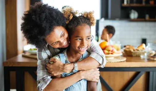 mom hugging daughter