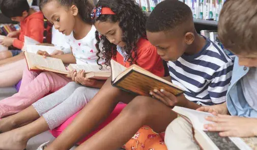 Photo of children reading books together