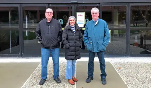 From left, John Sheridan, Kathi Knight and Michael Hennessey outside Grupp Hall.