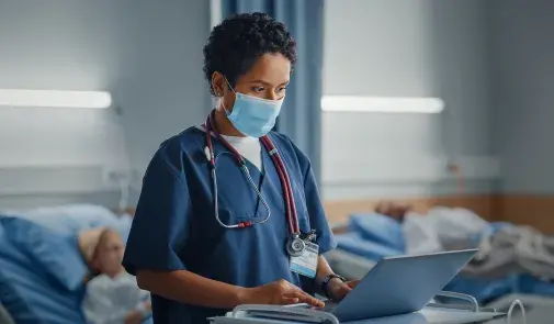 Healthcare worker at laptop