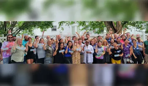 Photo of United Faculty of ISU members standing together, smiling with raised fists