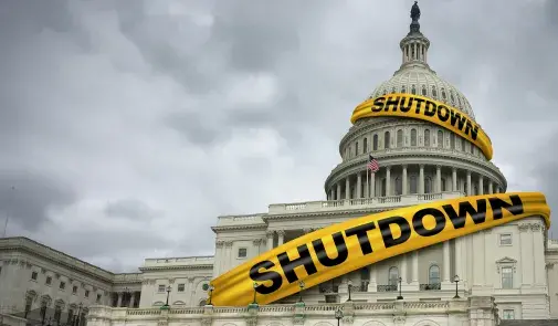 Photo of Capitol building wrapped in yellow tape that reads "Shutdown"