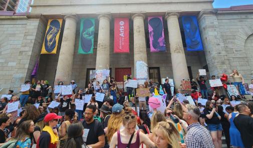 Photo of large group of students and community members rallying on the steps of the University of the Arts in Philadelphia 