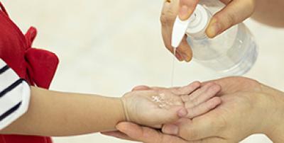 Child getting hand sanitizer