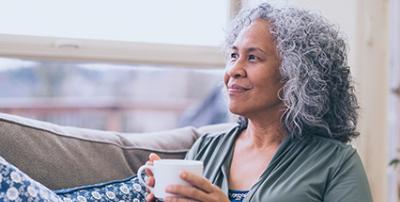 older person with coffee cup