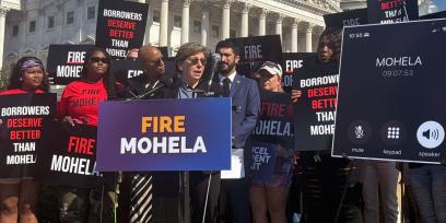 AFT President Randi Weingarten speaking to press at an outdoor conference surrounded by signs and people supporting the FIRE MOHELA movement