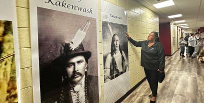 AFT Executive Vice President Evelyn DeJesus admires posters of Chief Kakenwash.