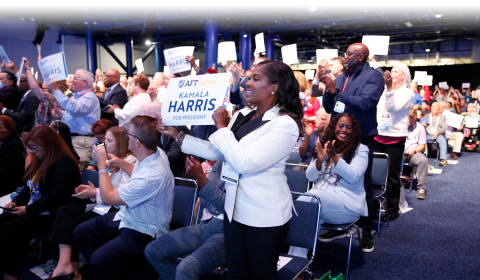 AFT members hold up signs reading "Kamala Harris for President" at AFT Convention 2024
