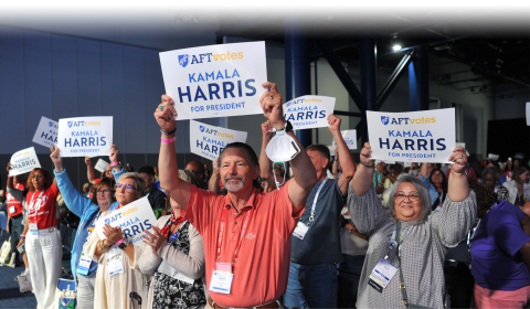 AFT members hold up signs reading "Kamala Harris for President" at AFT Convention 2024